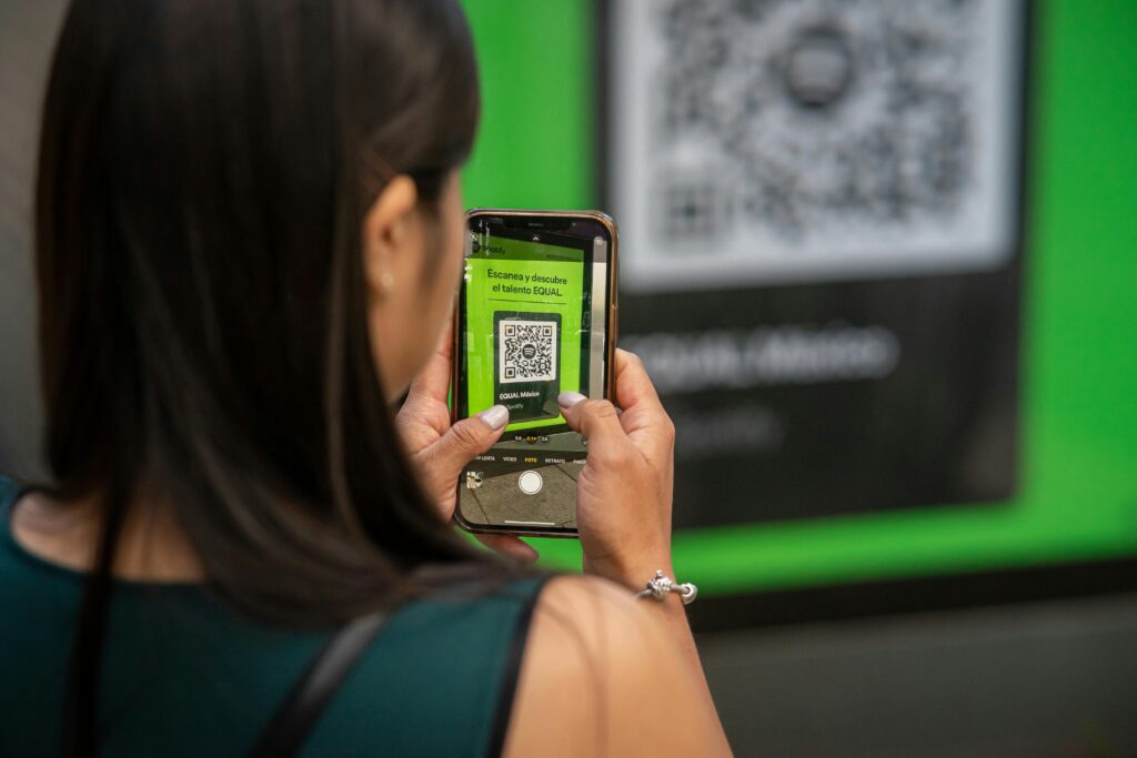 Person scans QR Code using phone